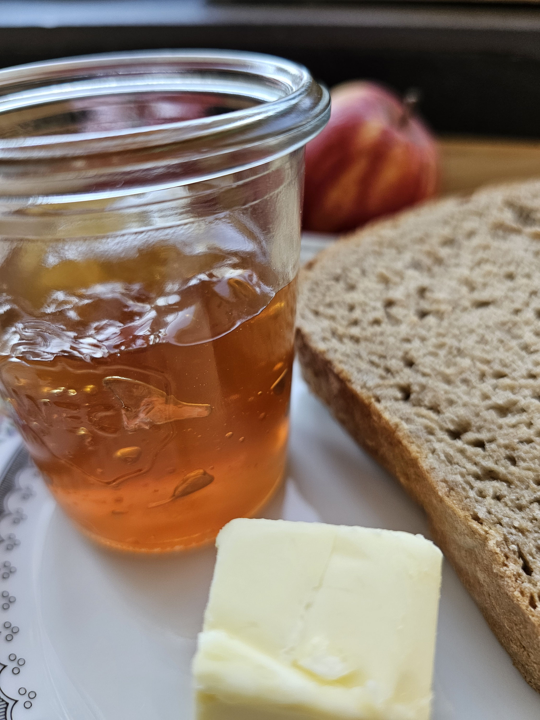 Goldenes Apfelgelee im Glas zum Frühstück.