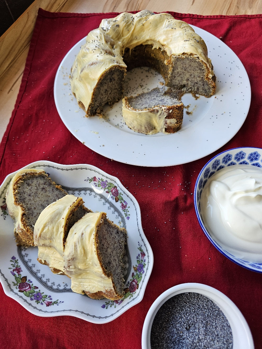 Angeschnittener Mohn-Joghurt-Gugelhupf mit Vanilleglasur.